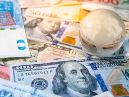 World globe crystal on various banknotes