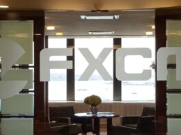 An FXCM logo in an office space