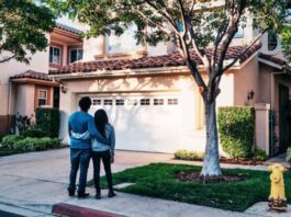 An image of a couple looking at a house to represent why homeowners aren’t selling